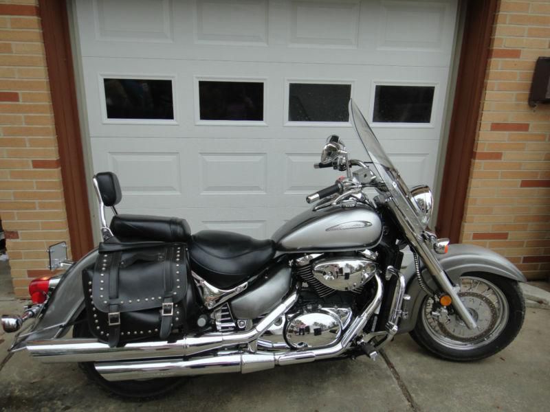 Very low miles, garage kept, excellent condition. Silver/Chrome with saddle bags